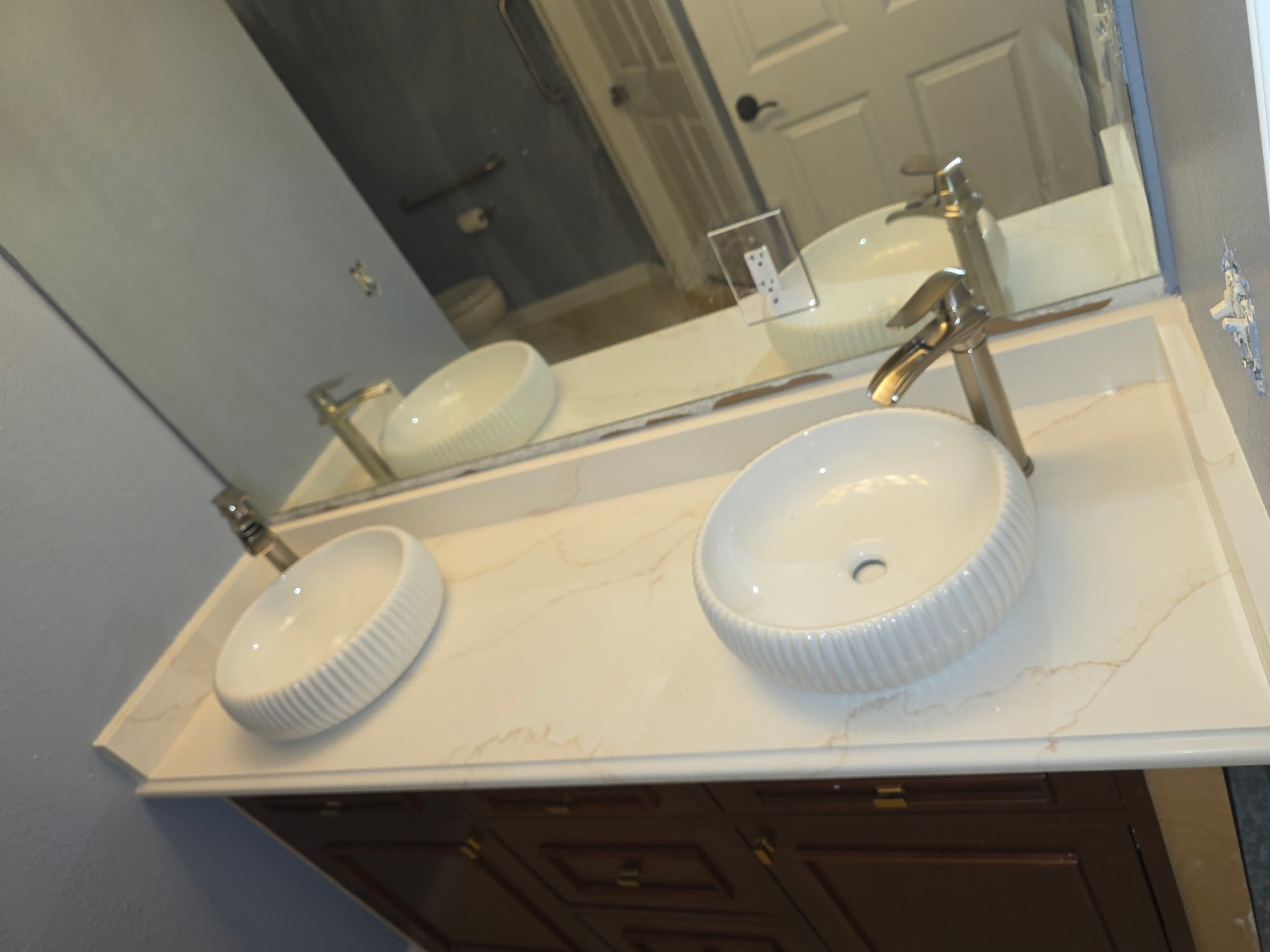 Double sink bathroom with quartz countertop and vessel sinks