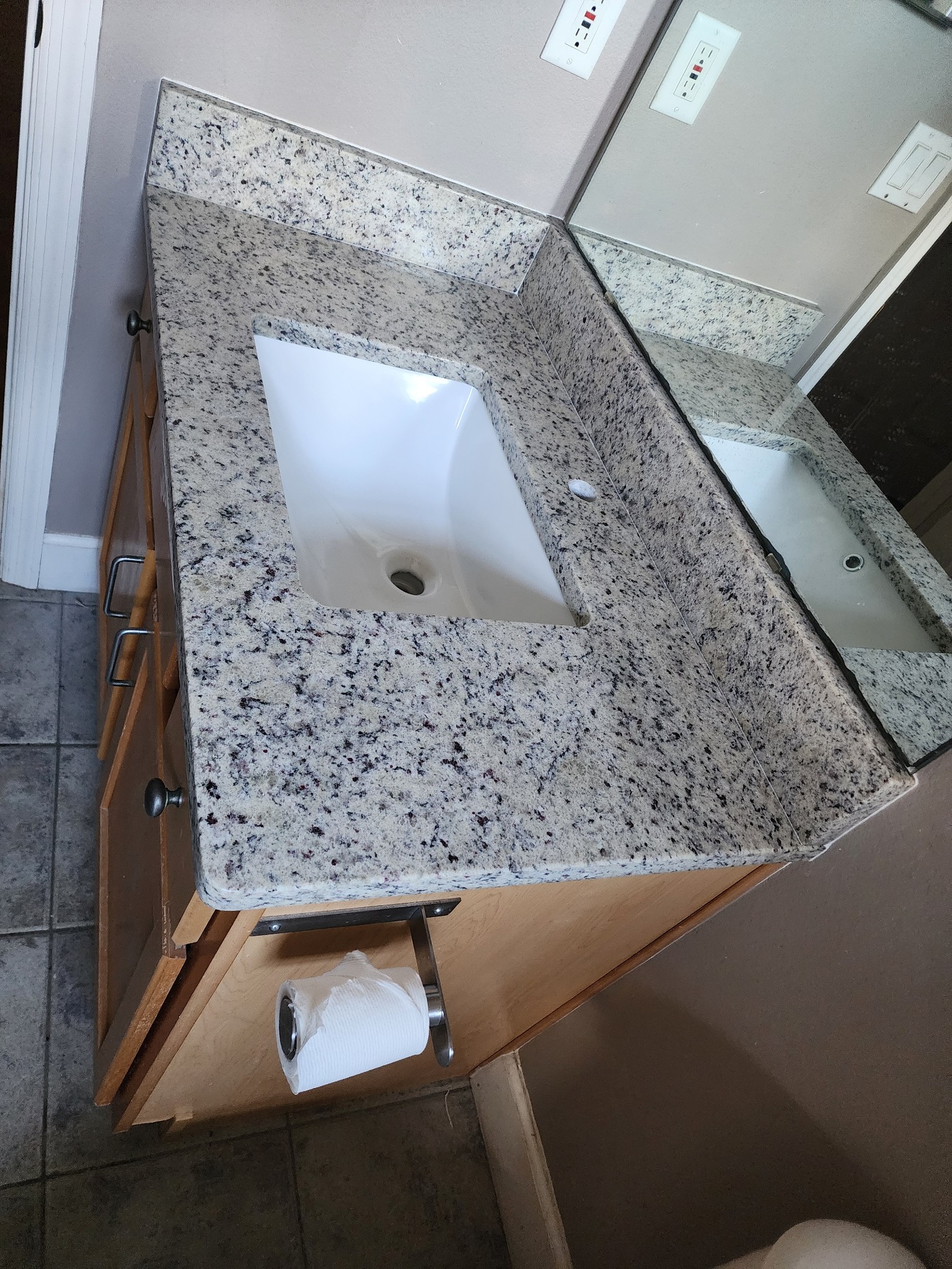 Granite top bathroom vanity with white cabinetry