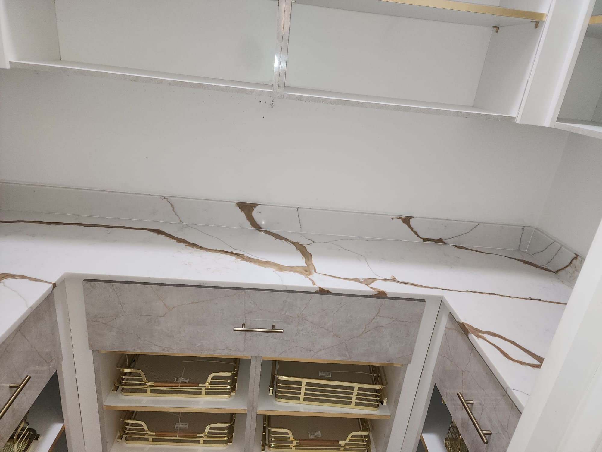 Walk-in closet with calacatta marble shelving