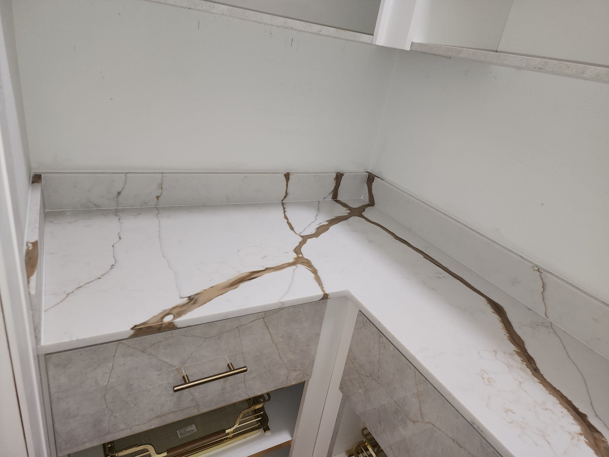Calacatta marble countertop corner detail with gold veining