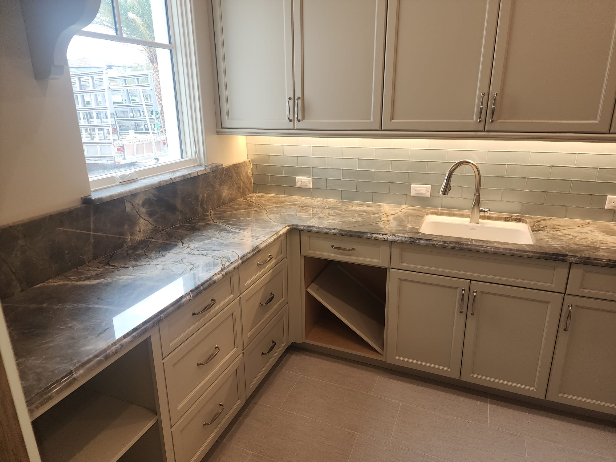 Dark granite kitchen countertop with subway tile backsplash