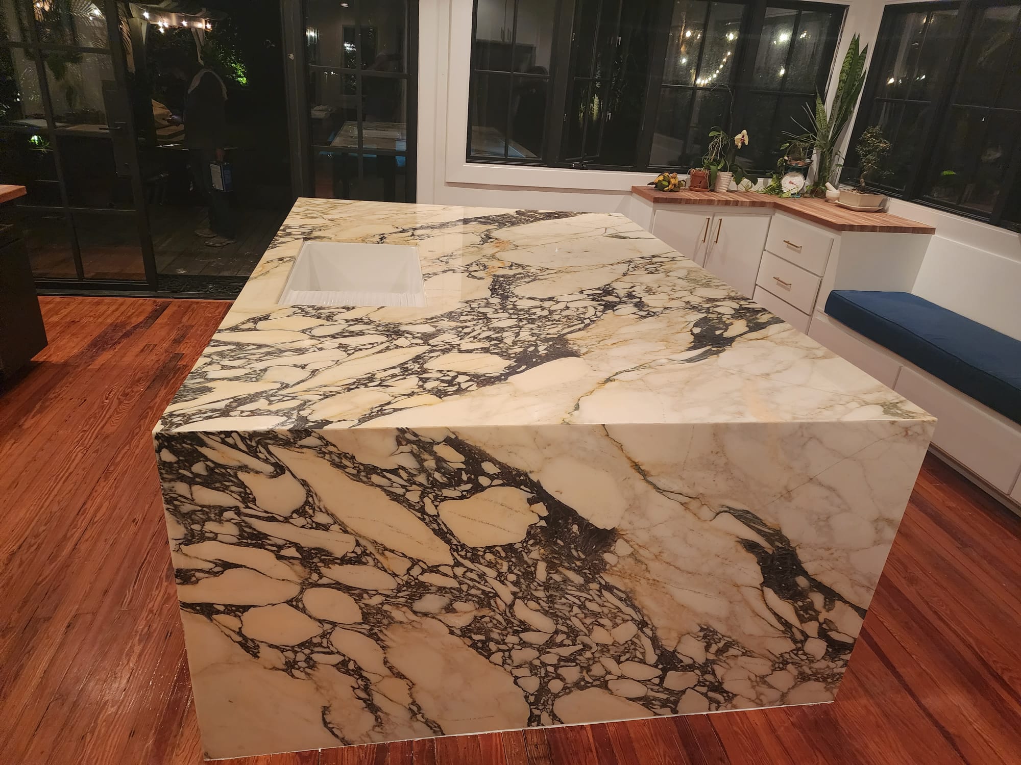 Dramatic marble waterfall island with striking veining pattern